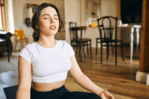 A woman practicing mindful breathing to manage her anxiety