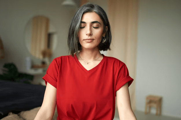 A female trying different breathing exercises to manage her anxiety attacks