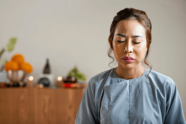 A woman restoring her calm and balance by practicing mindful breathing