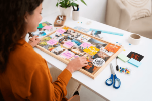 A woman creating her vision board to manifest and visualize her future