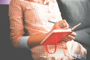 Women practicing journal prompts for self discovery as mid-year reflection