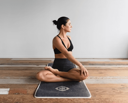 A woman doing yoga to cope with her social anxiety
